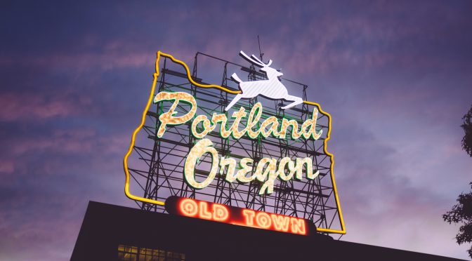 Neon Portland Oregon Sign on brick building at dusk